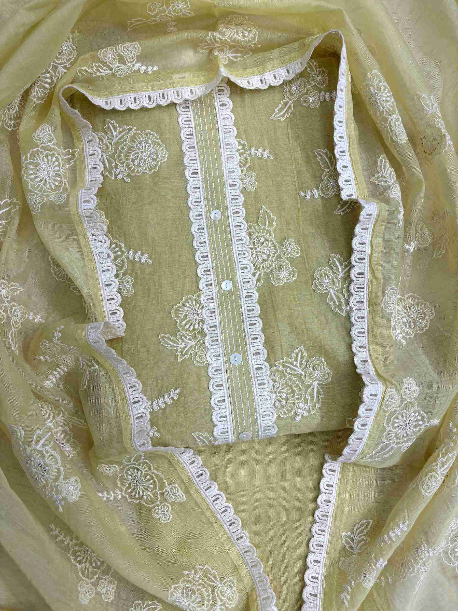 Lace highlighting at neckline and front placket of sage green mul chanderi shirt