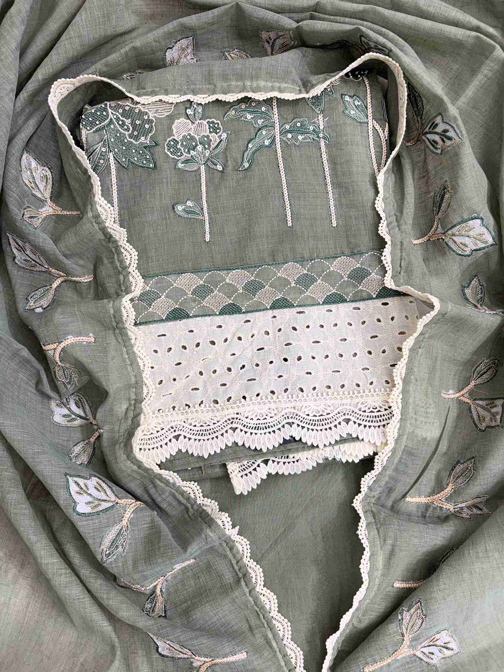 Close-up of thread embroidery with sequin and bead work on sage green mul chanderi shirt