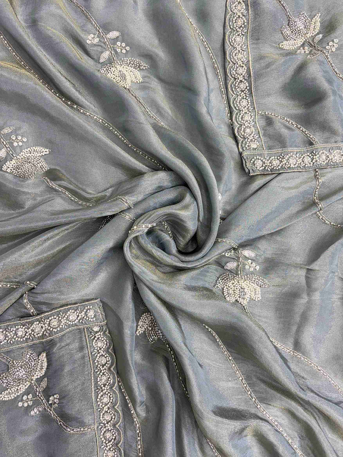 Diagonal bead and sequin lines with floral embellishments across sage grey-green soft tissue dupatta surface