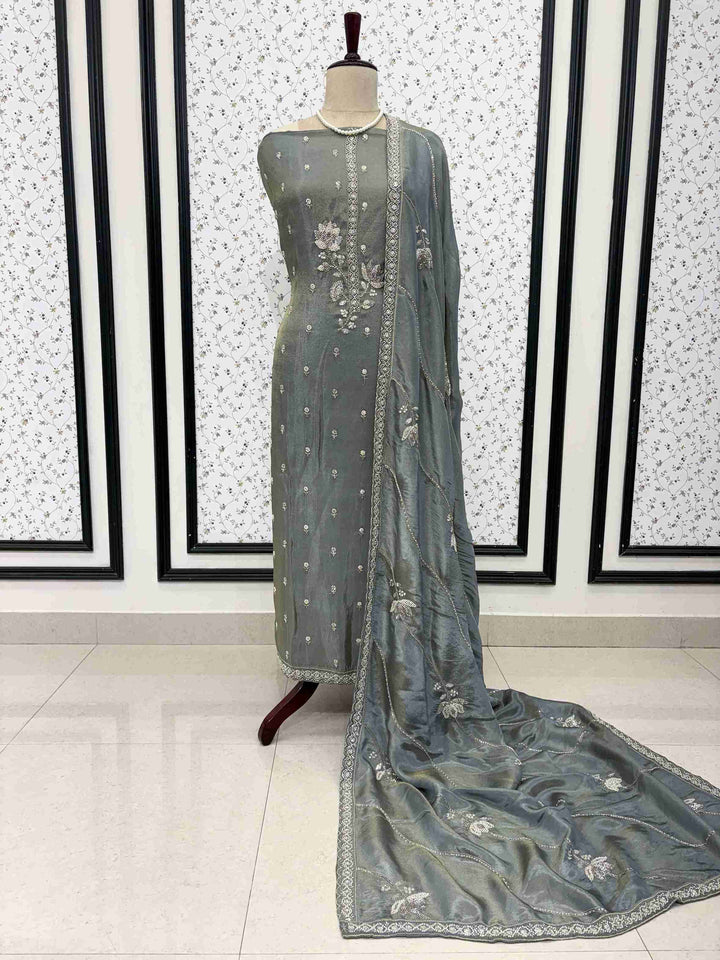 Silver zari and sequin floral embroidered border detail along sage grey-green soft tissue dupatta edges