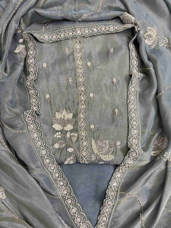 Scattered handwork booties detail across the full front of sage grey-green soft tissue unstitched shirt
