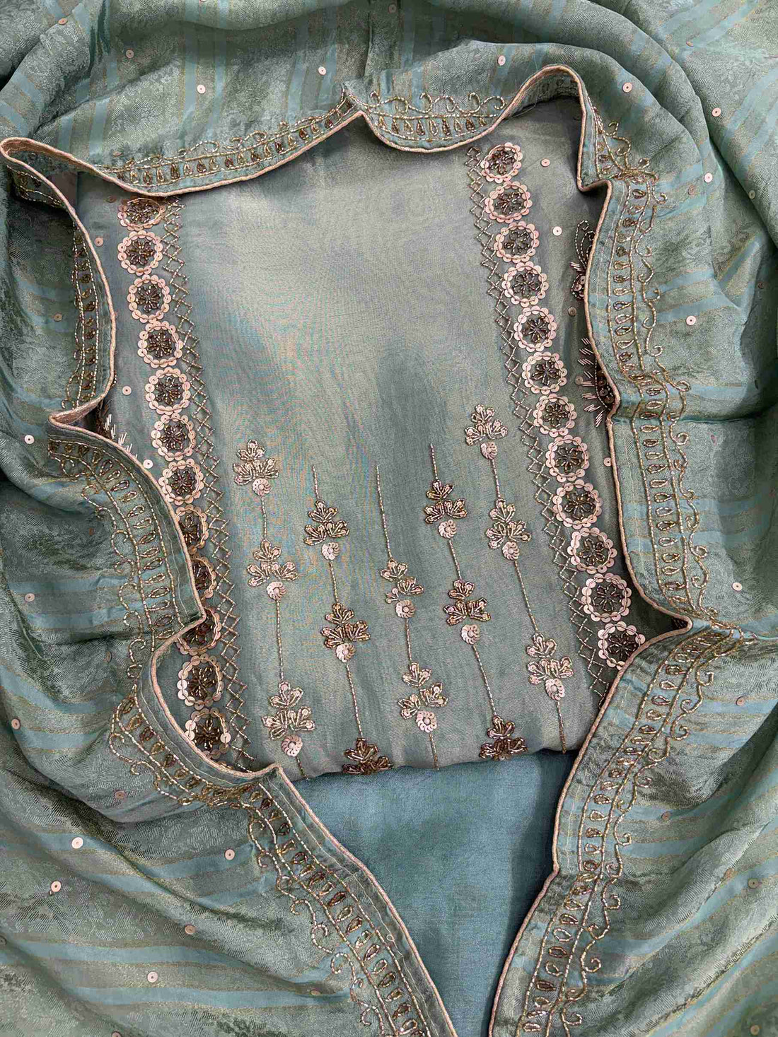 Front view of sea green shimmer organza heavy handwork unstitched suit set