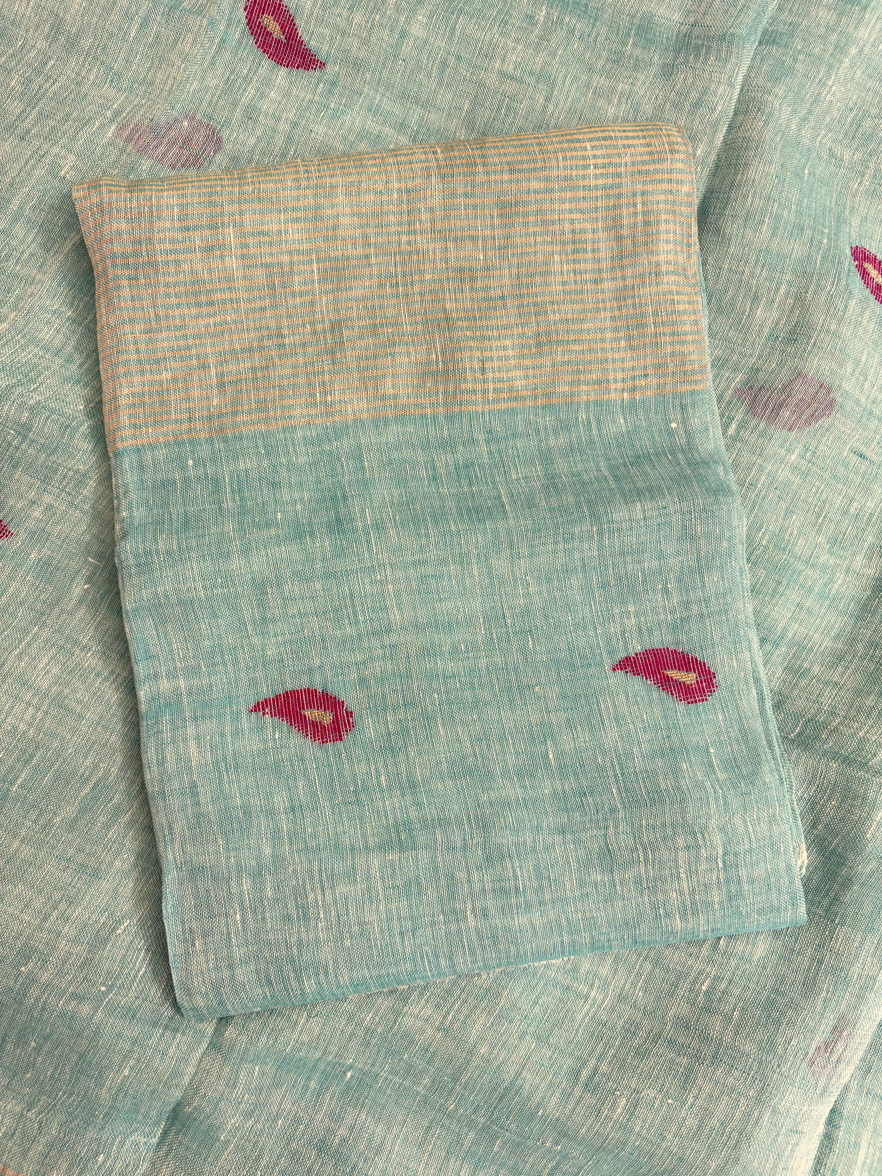 Scattered small pink paisley woven motifs across peach linen dupatta surface