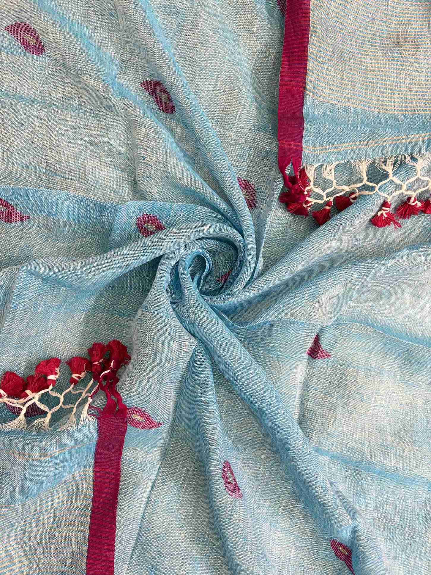 Scattered small pink paisley woven motifs across sky blue linen dupatta surface