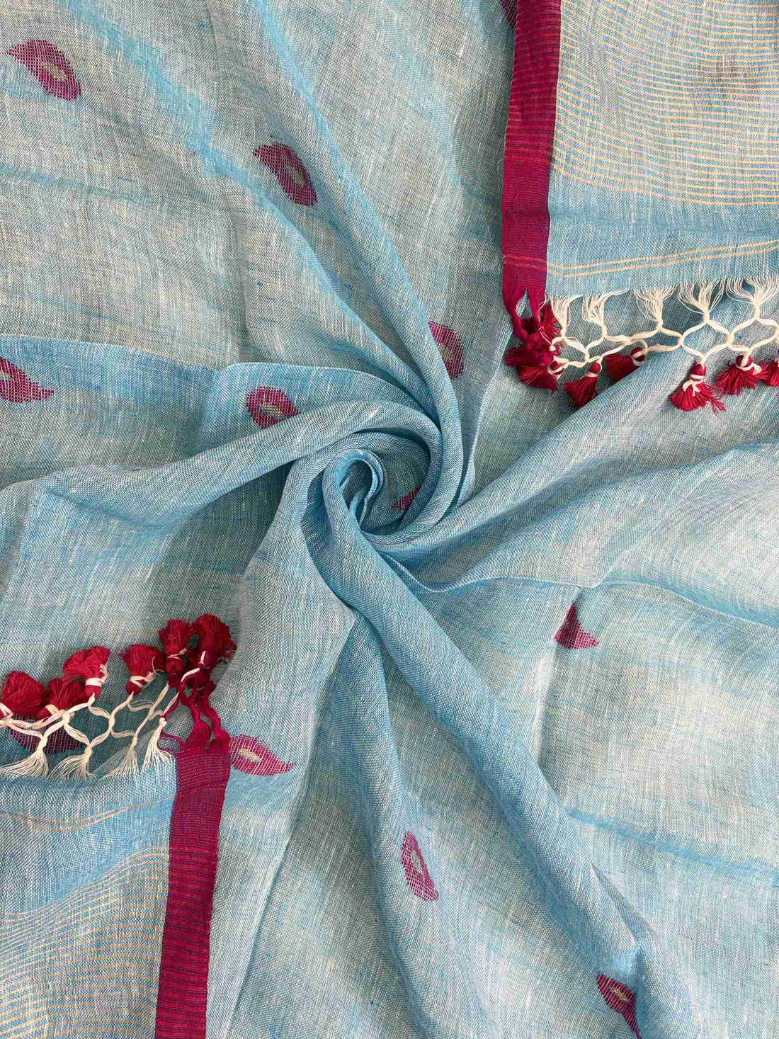 Scattered small pink paisley woven motifs across sky blue linen dupatta surface