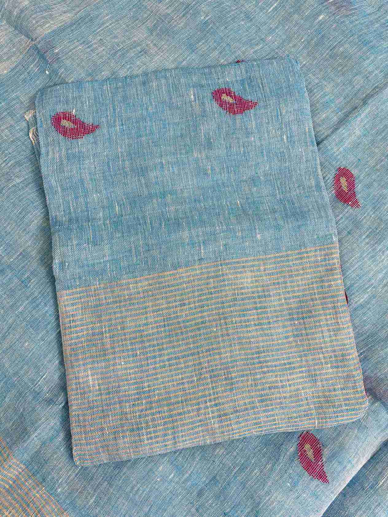 Scattered small pink paisley woven motifs across sky blue linen shirt body