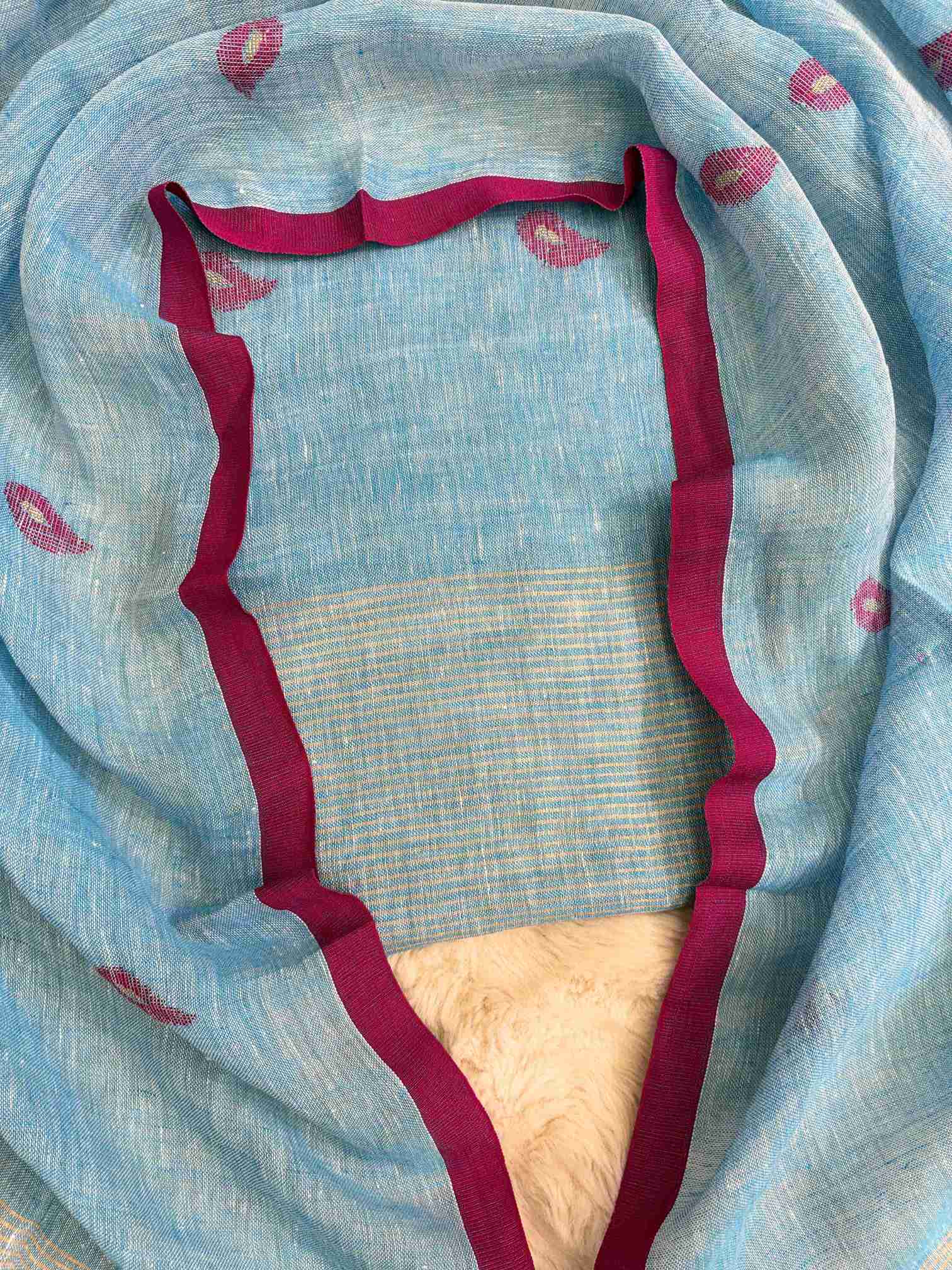 Complete sky blue linen unstitched 2-piece suit flat lay with shirt and dupatta showing pink paisley motifs and golden stripe