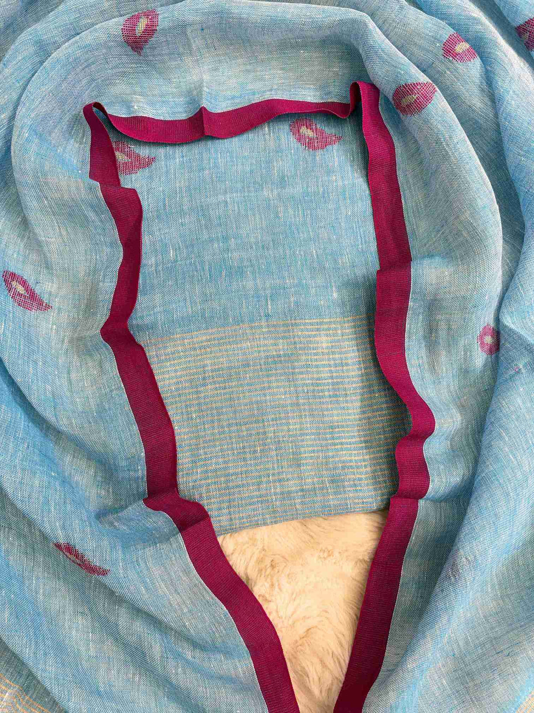 Complete sky blue linen unstitched 2-piece suit flat lay with shirt and dupatta showing pink paisley motifs and golden stripe