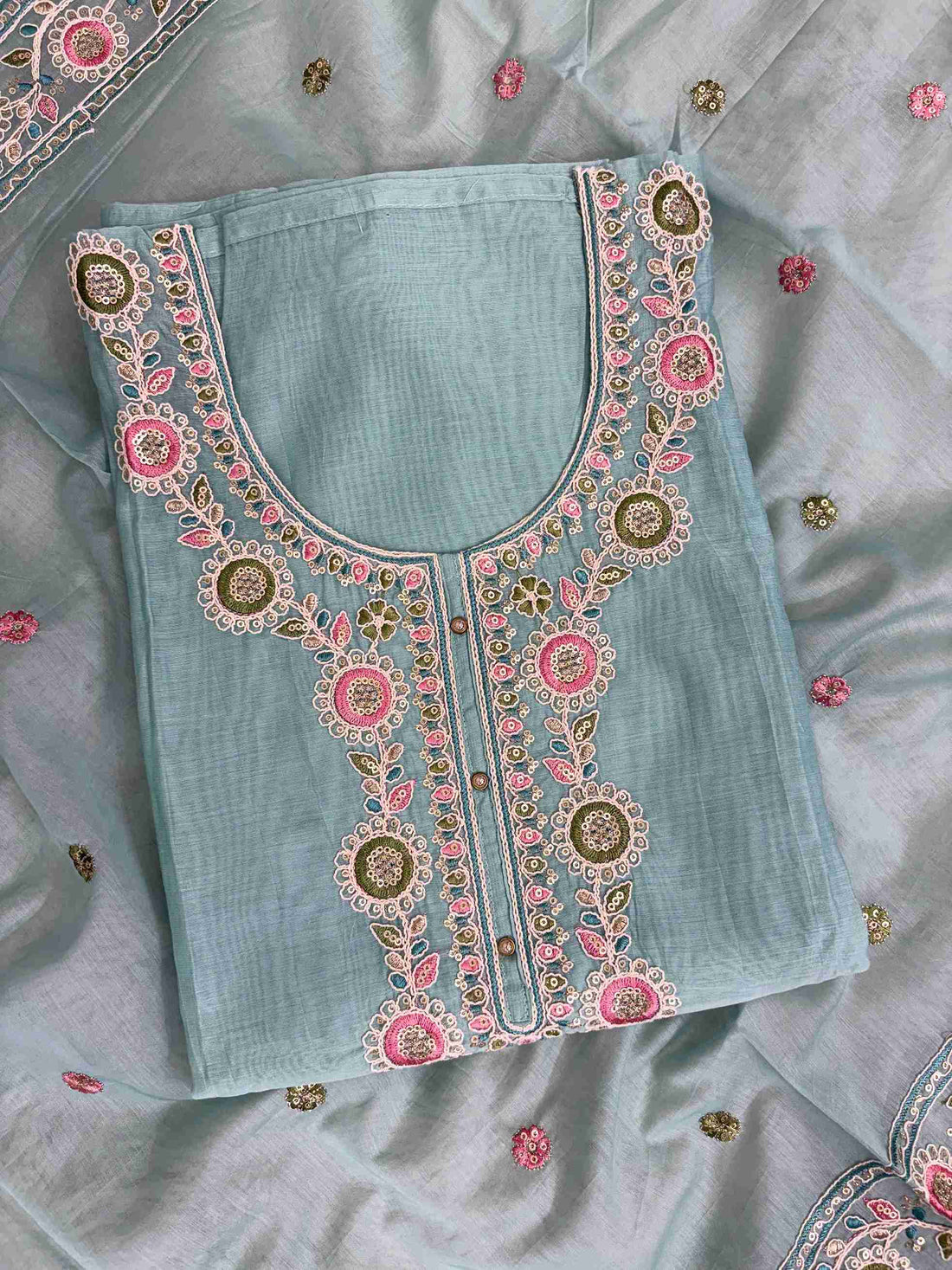 Multicolor thread embroidered floral motifs with mirror work at neckline and front placket of sky blue mul chanderi shirt