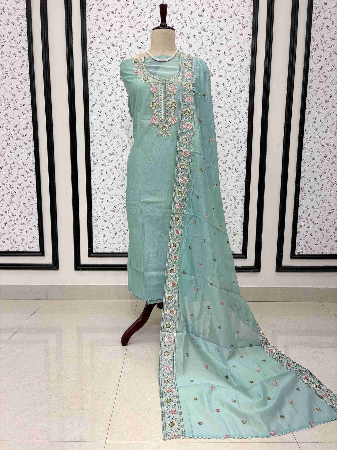 Sky blue mul chanderi unstitched suit full front view with embroidered booty dupatta draped on mannequin