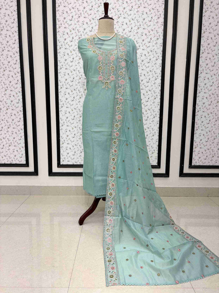 Sky blue mul chanderi unstitched suit full front view with embroidered booty dupatta draped on mannequin