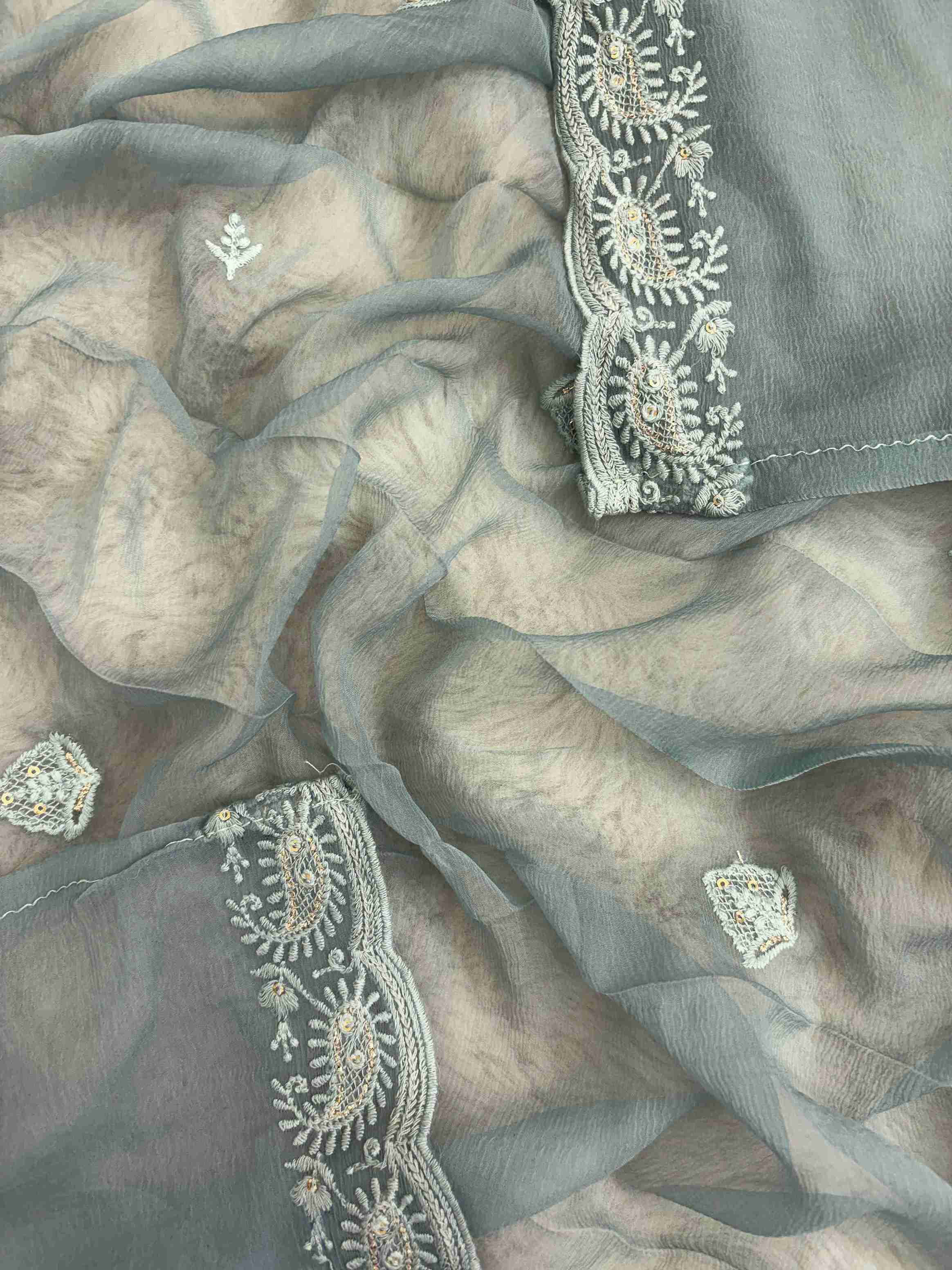 Scattered chikankari floral motifs across the surface of steel blue chiffon dupatta