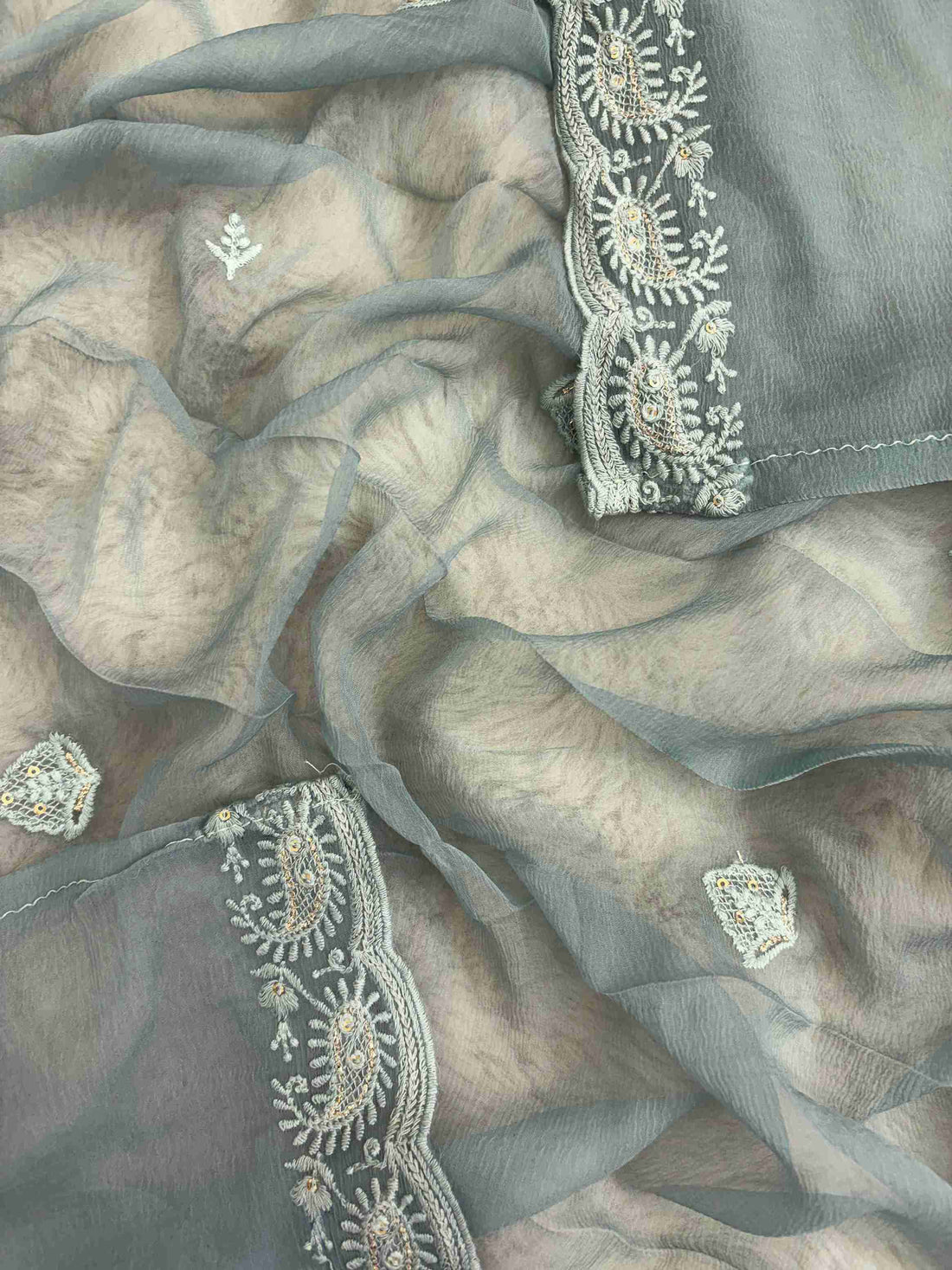Scattered chikankari floral motifs across the surface of steel blue chiffon dupatta