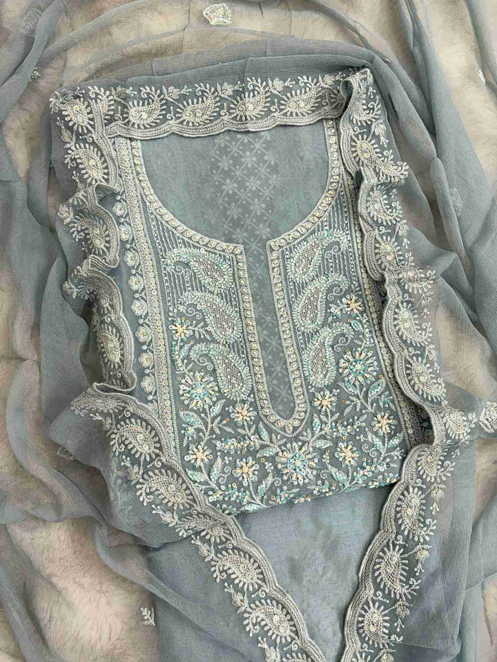 Close-up of chikankari neckline panel with moti, bead, and sequin embellishment on steel blue georgette shirt