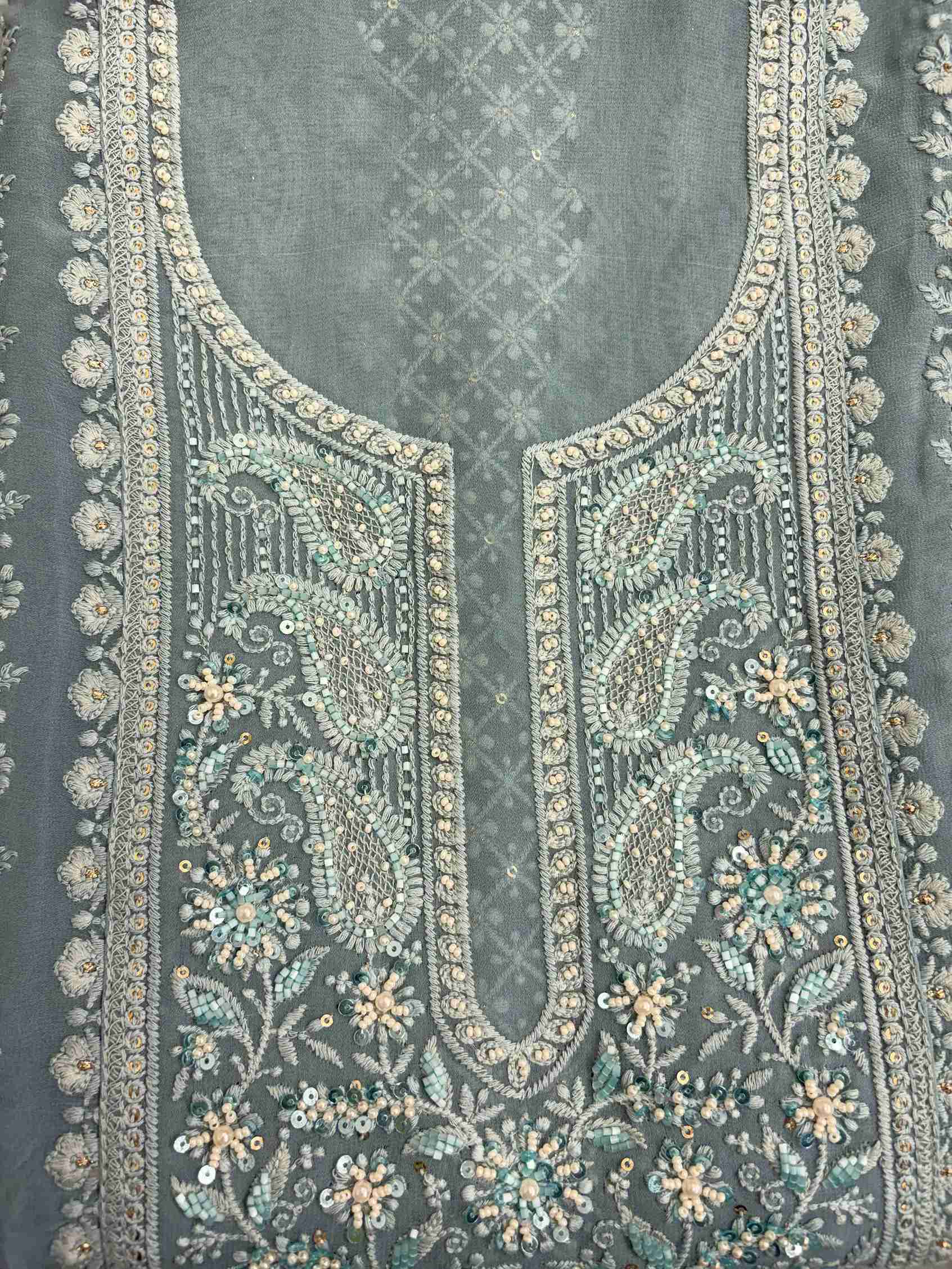 Geometric chikankari panel with paisley and floral motifs on steel blue georgette shirt front