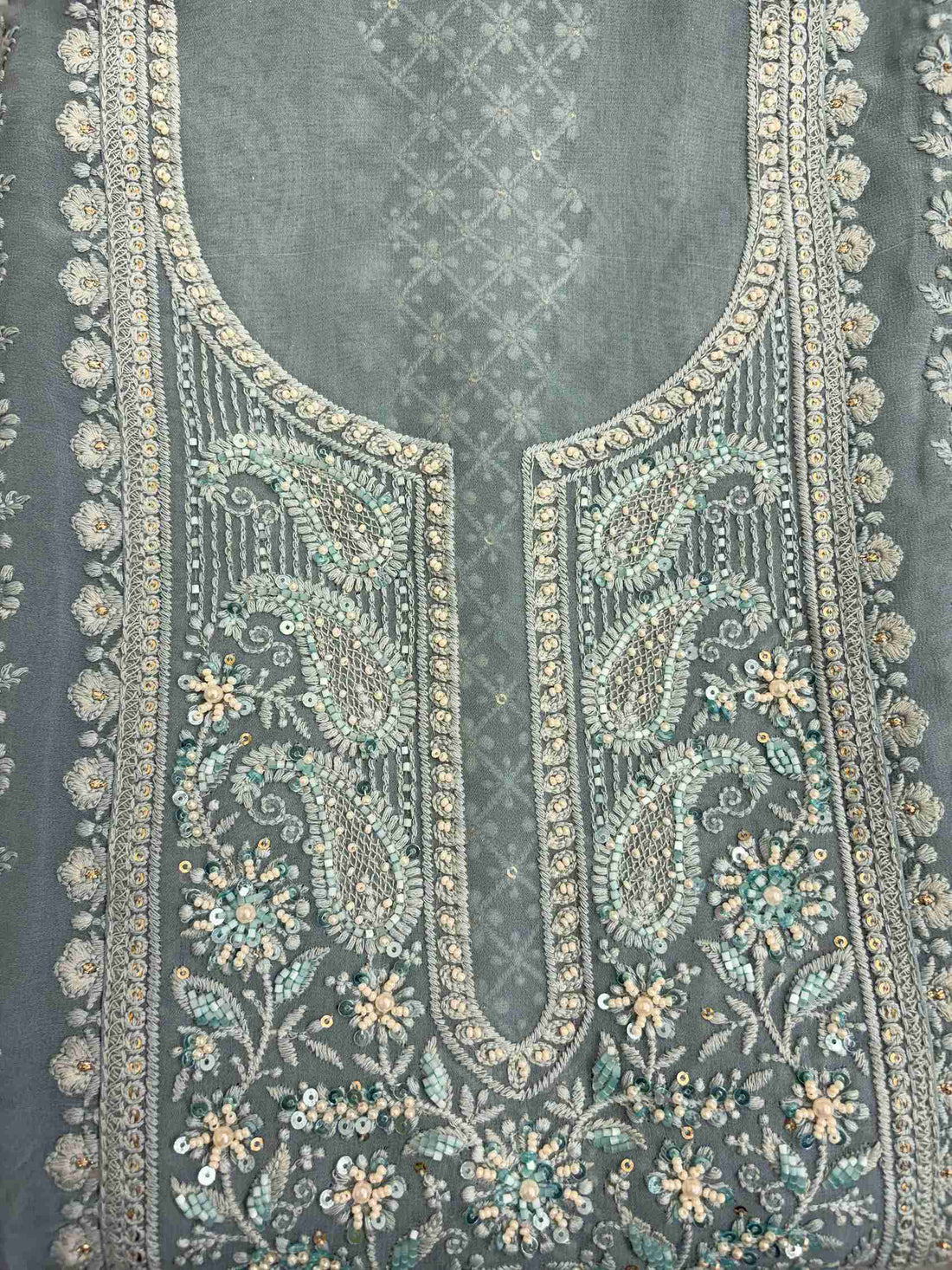 Geometric chikankari panel with paisley and floral motifs on steel blue georgette shirt front