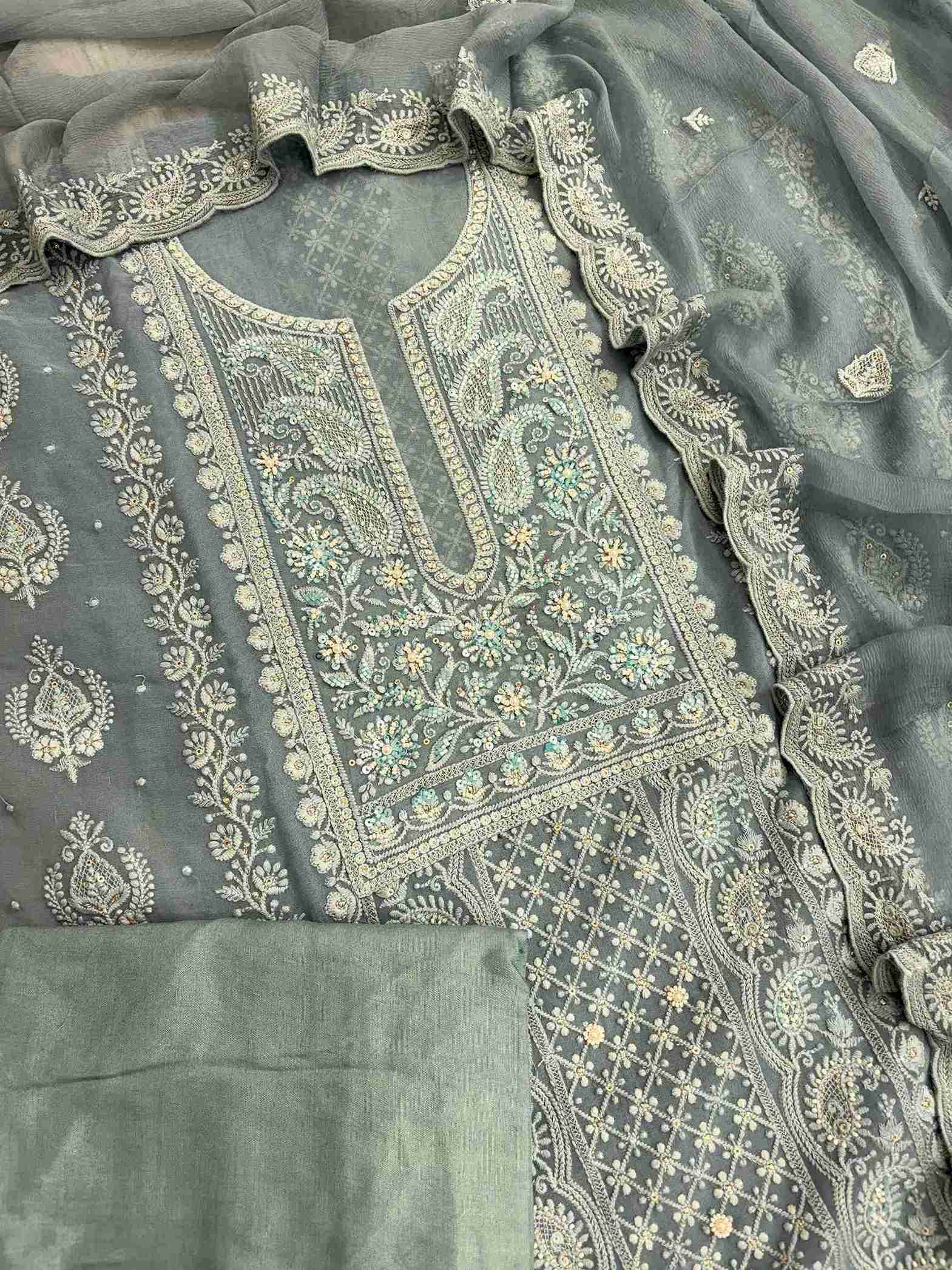 Complete steel blue georgette unstitched suit flat lay set with chikankari shirt, chiffon dupatta, and cotton silk bottom