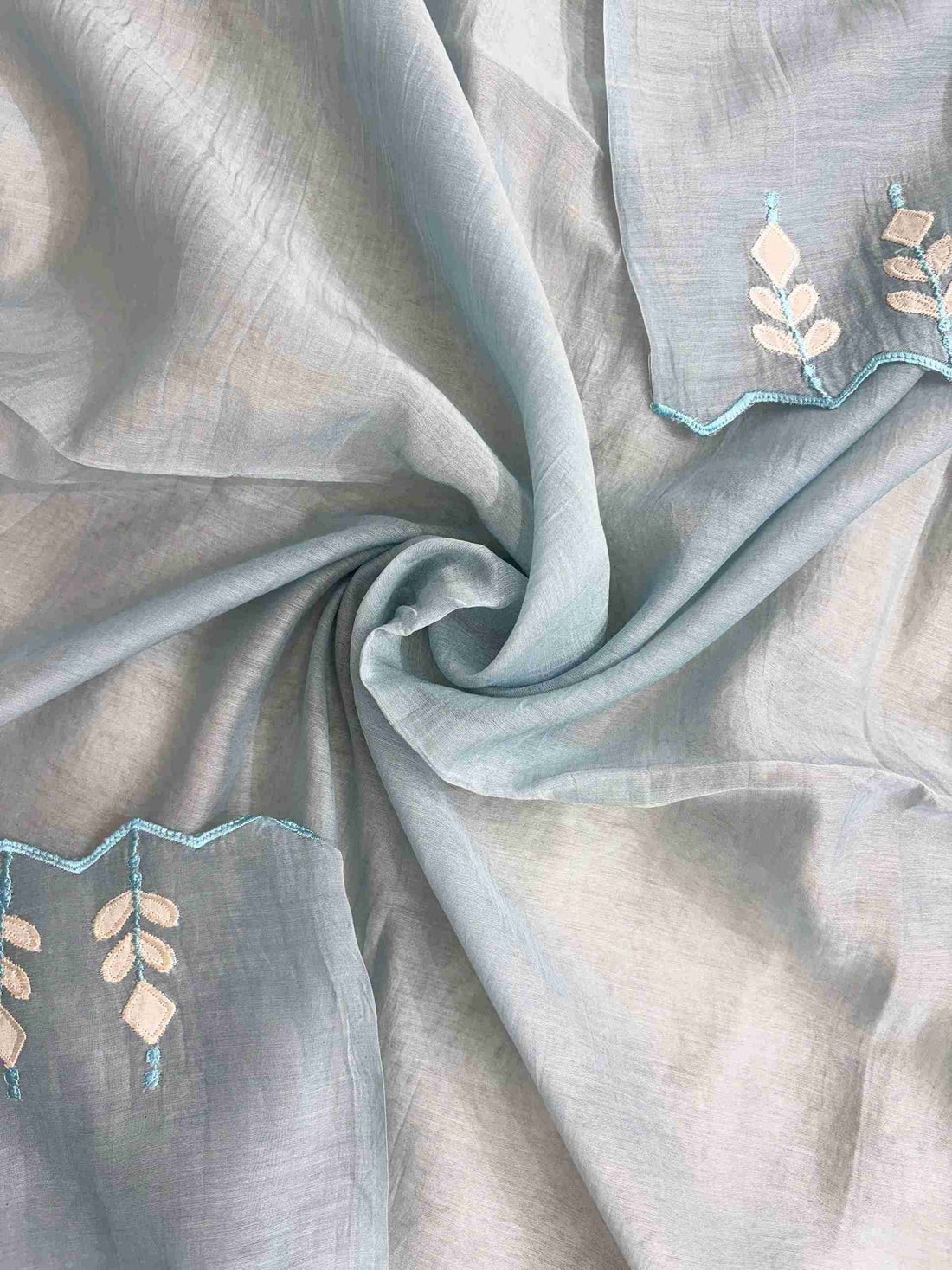 Applique patched cutwork border detail along steel blue mul cotton dupatta hem