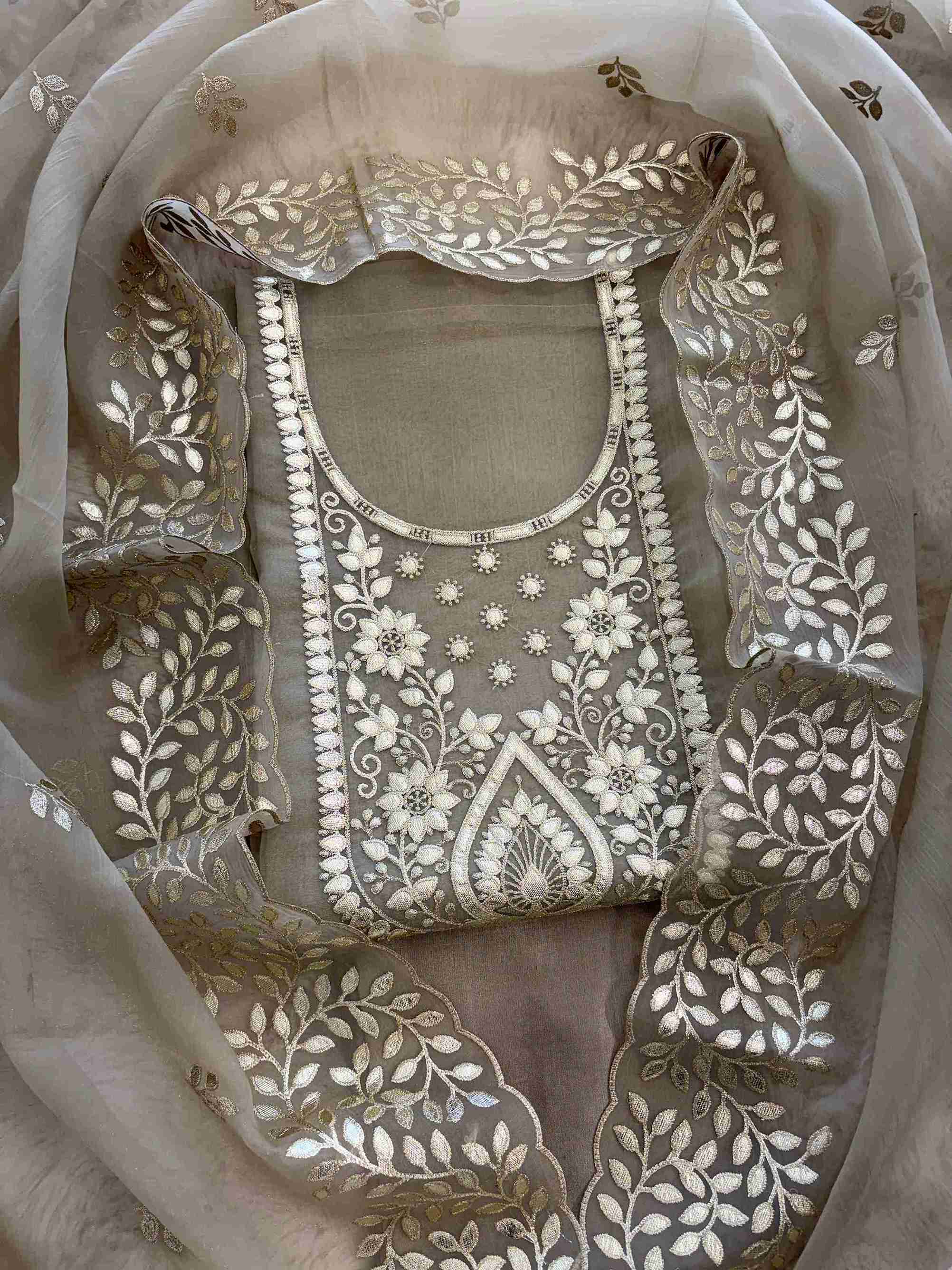 Leather gota border on the hemline of taupe beige shimmer tissue suit