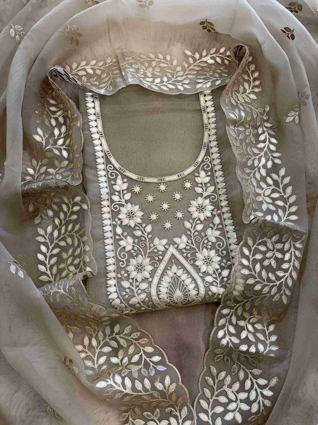 Leather gota border on the hemline of taupe beige shimmer tissue suit