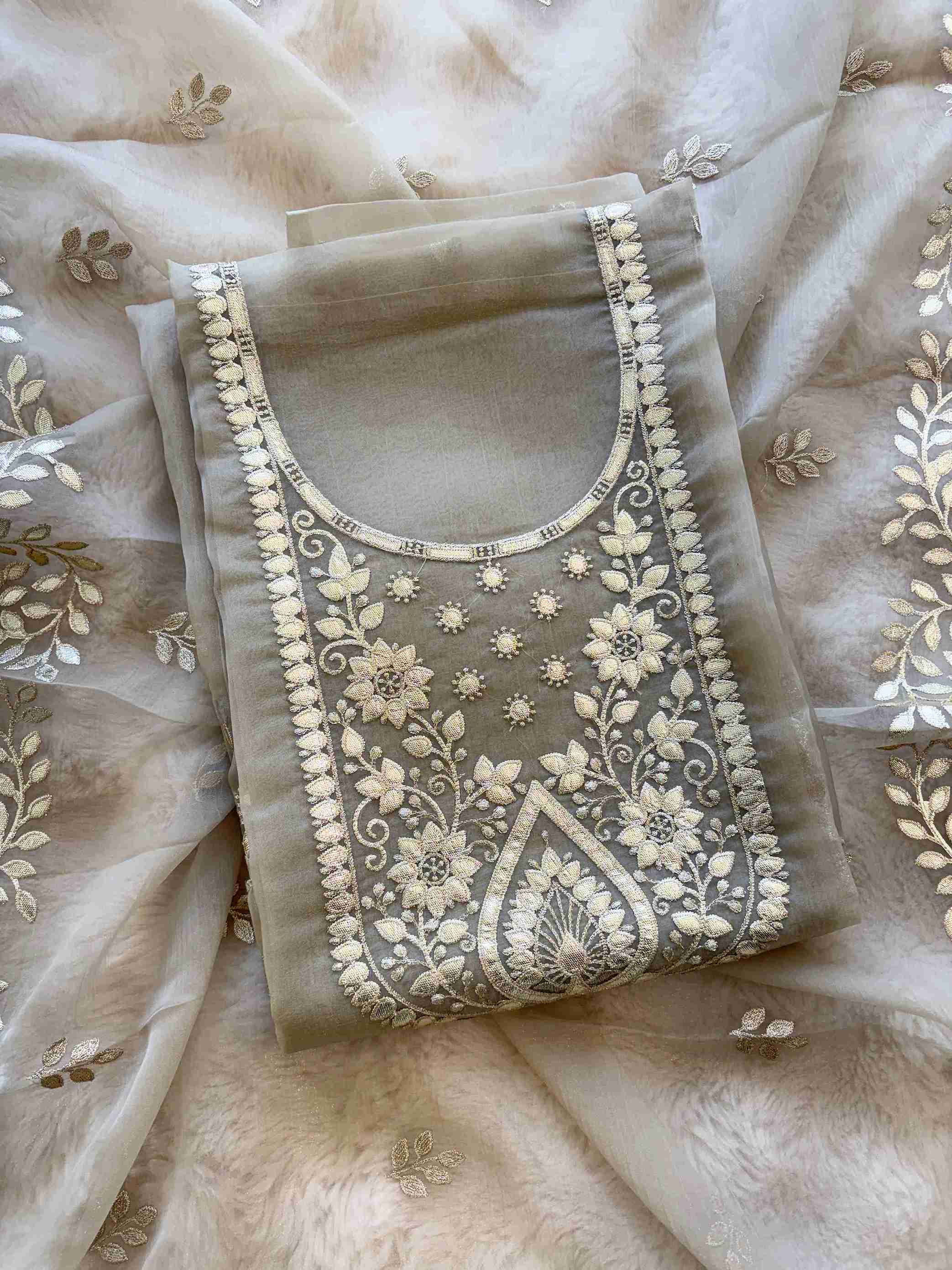 Close-up of leather gota work neckline on taupe beige shimmer tissue suit