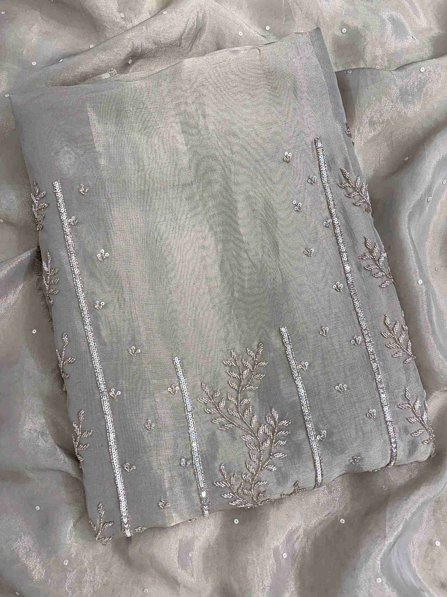 Close-up of taupe suit featuring detailed nalki, sequence and cutdana hand embroidery