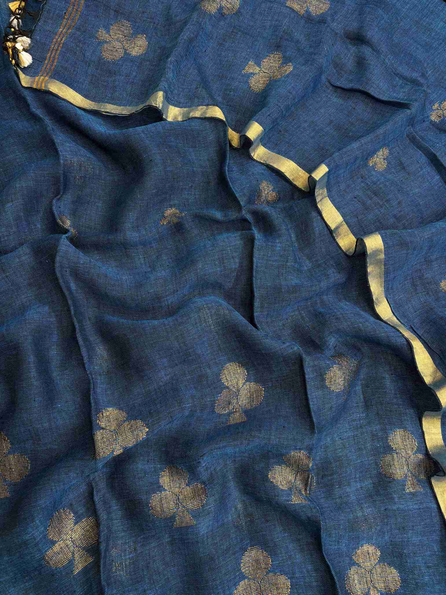 Scattered golden geometric spade woven motifs across teal blue pure handloom linen dupatta surface