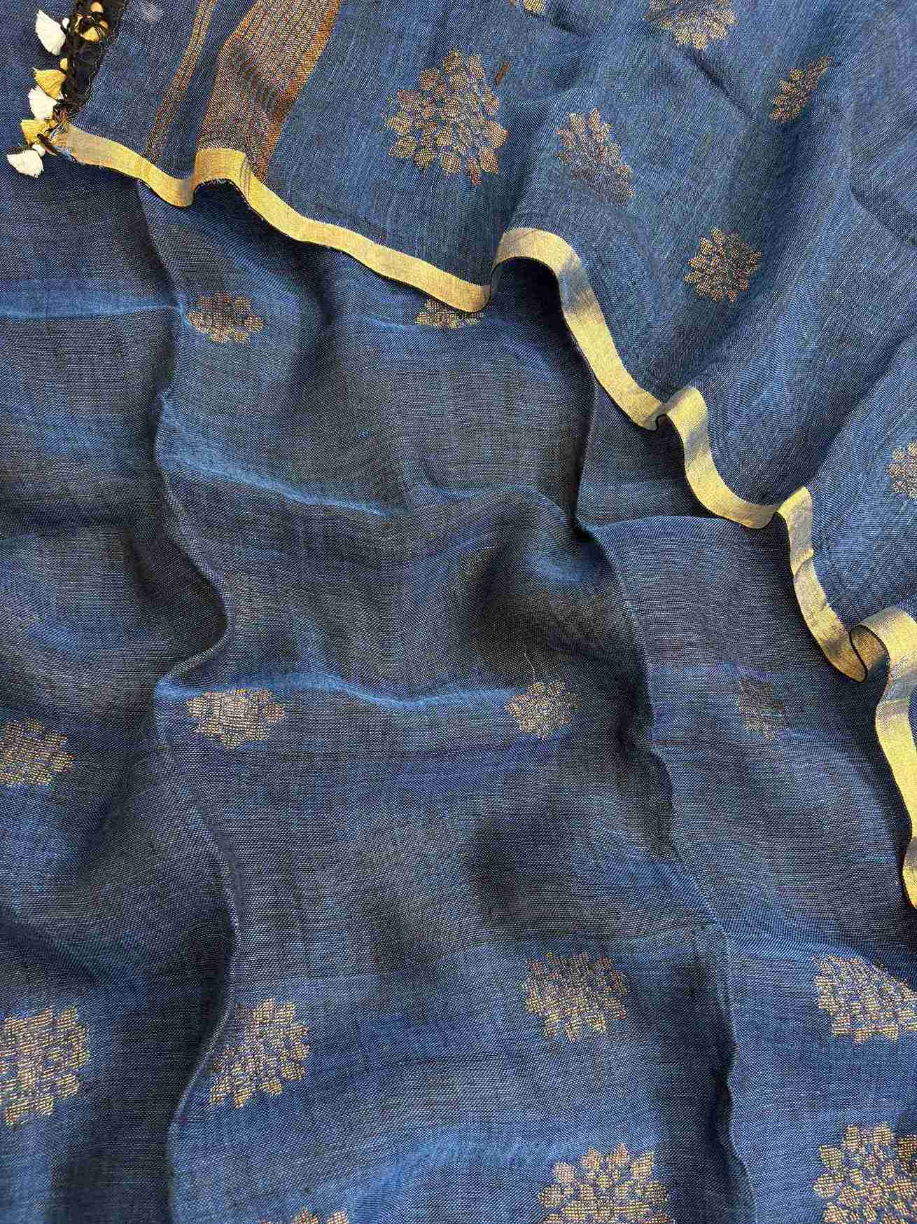 Scattered golden woven floral cluster motifs across teal blue pure handloom linen dupatta surface