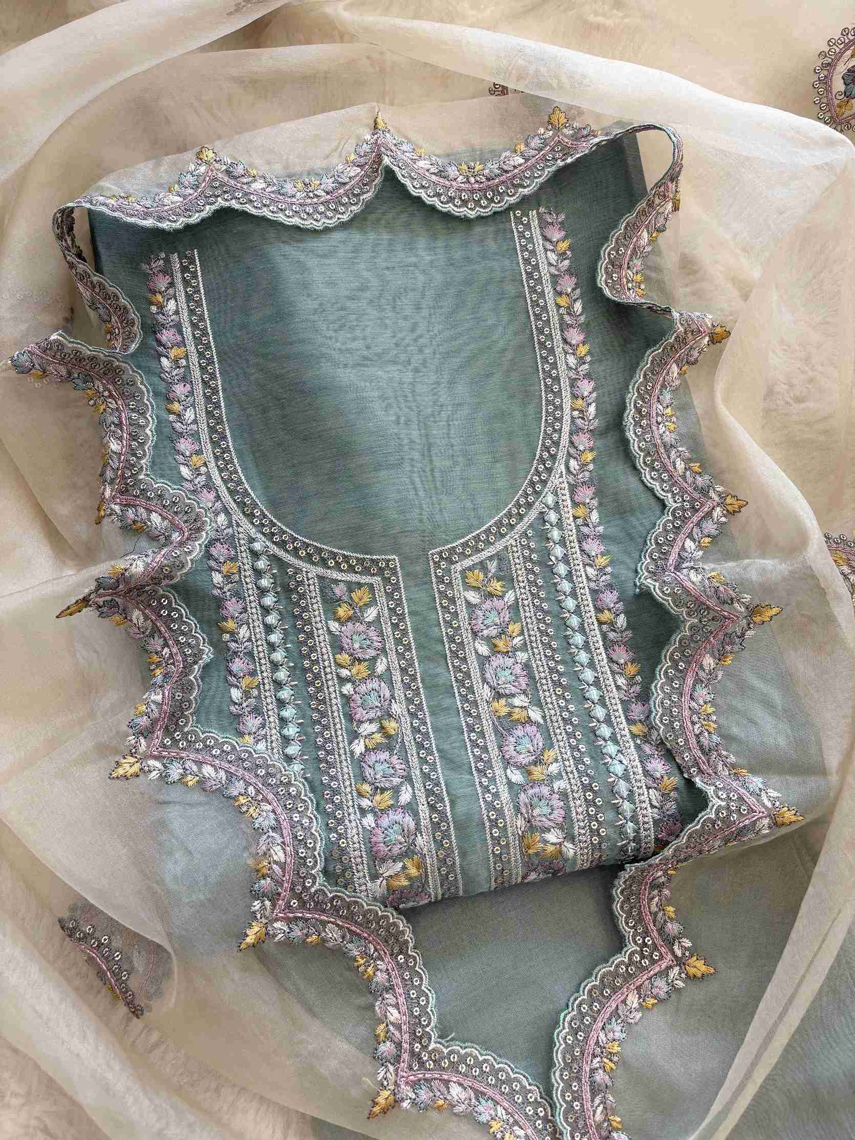 Front view of Khaadi Chanderi unstitched suit set with embroidered neckline and organza dupatta