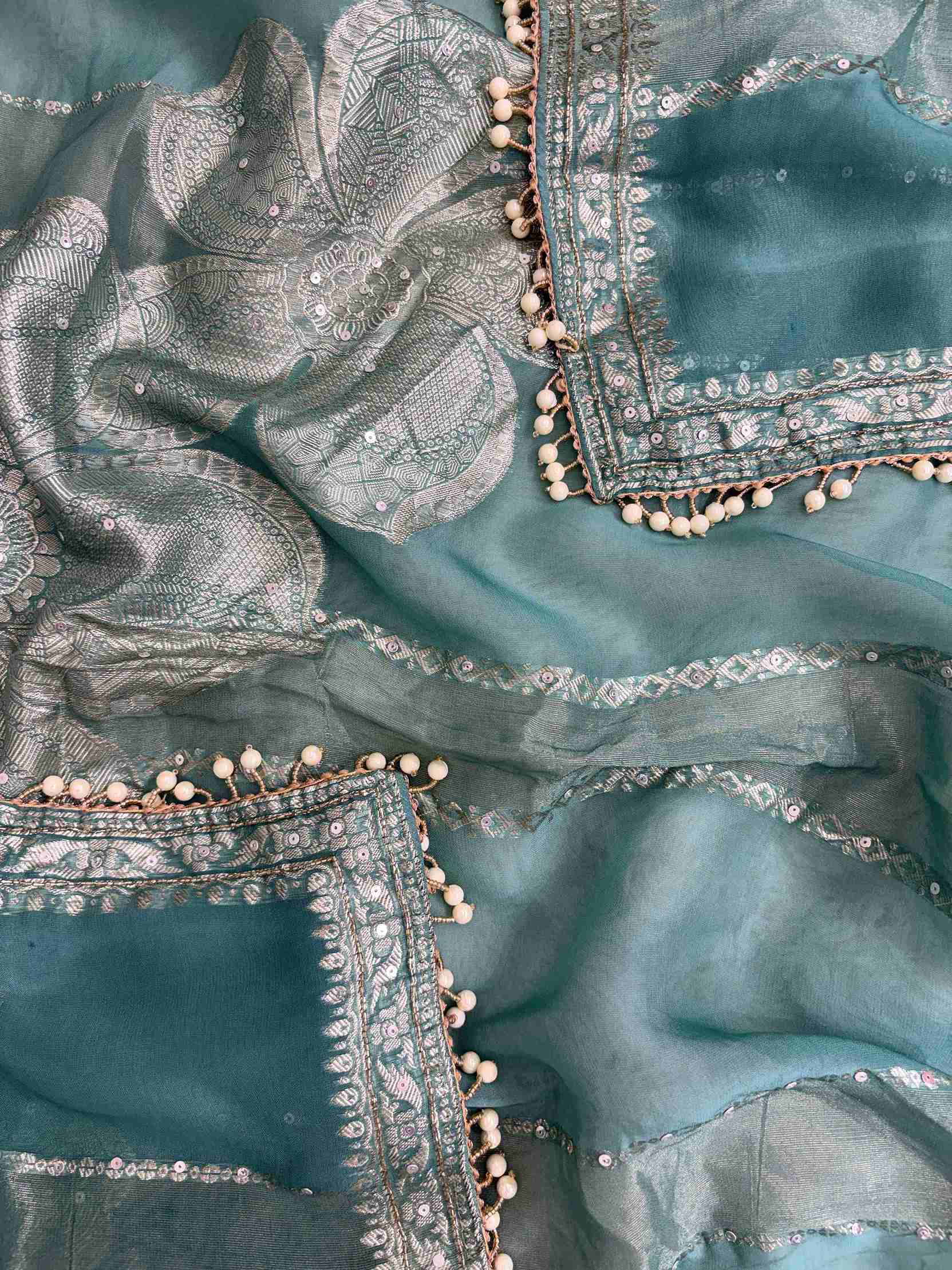 Teal organza dupatta edge finished with elegant moti tassels