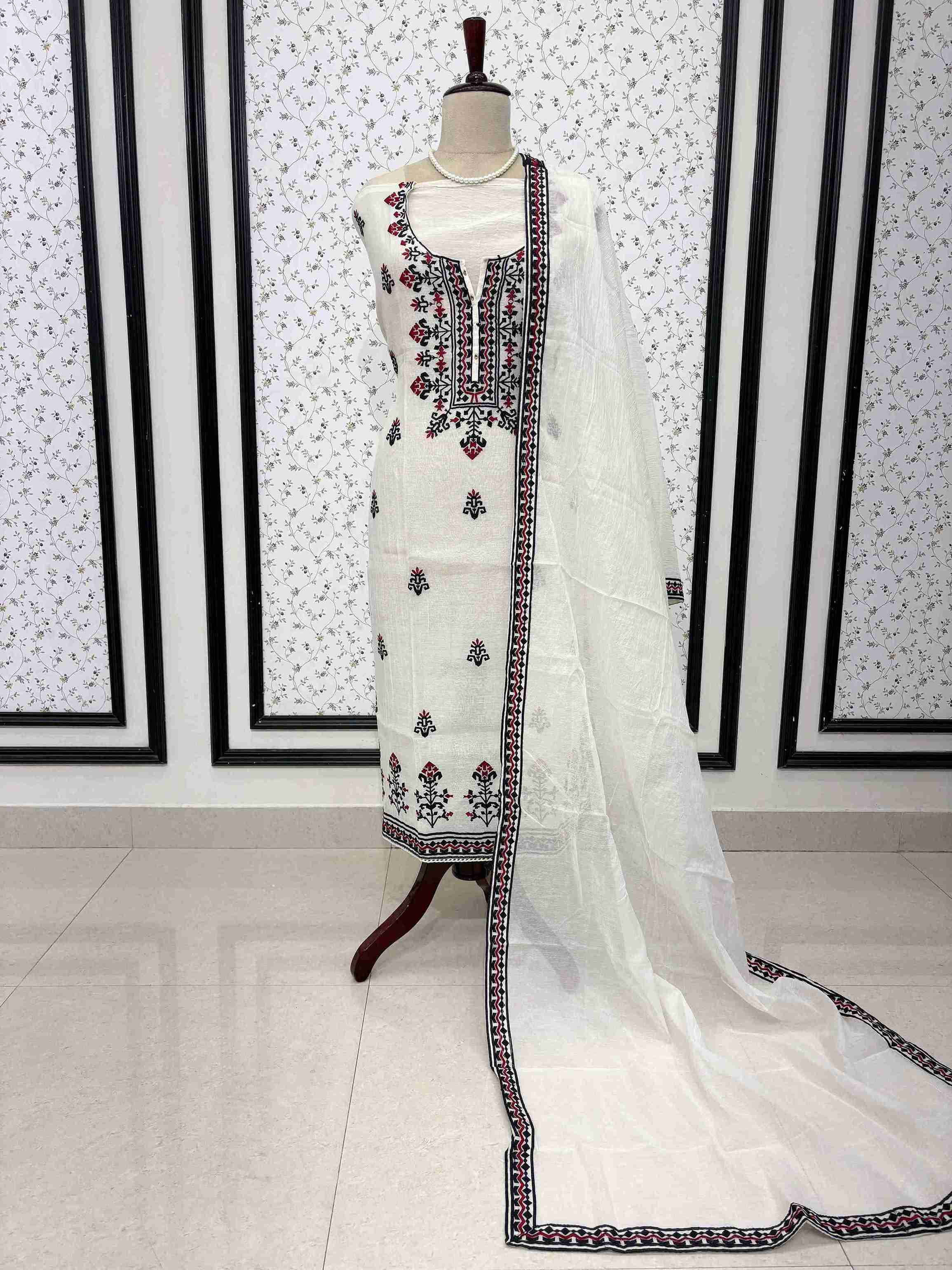 White mul chanderi unstitched suit full front view with geometric border dupatta draped on mannequin