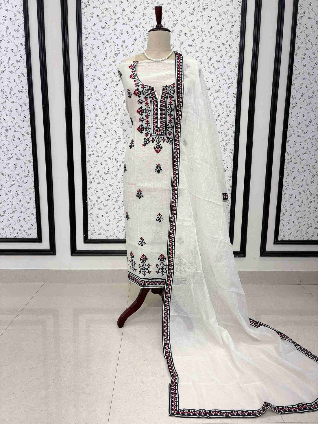White mul chanderi unstitched suit full front view with geometric border dupatta draped on mannequin