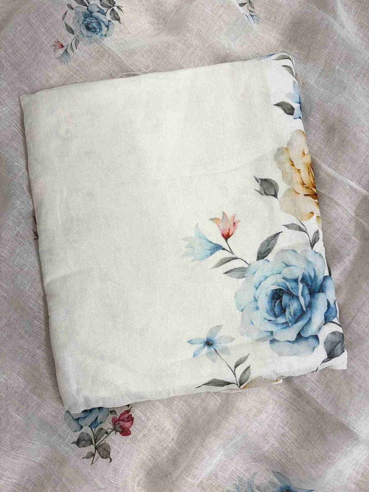 Close-up of digital blue roses, golden-amber roses, and pink accent flowers on white pure linen shirt hemline