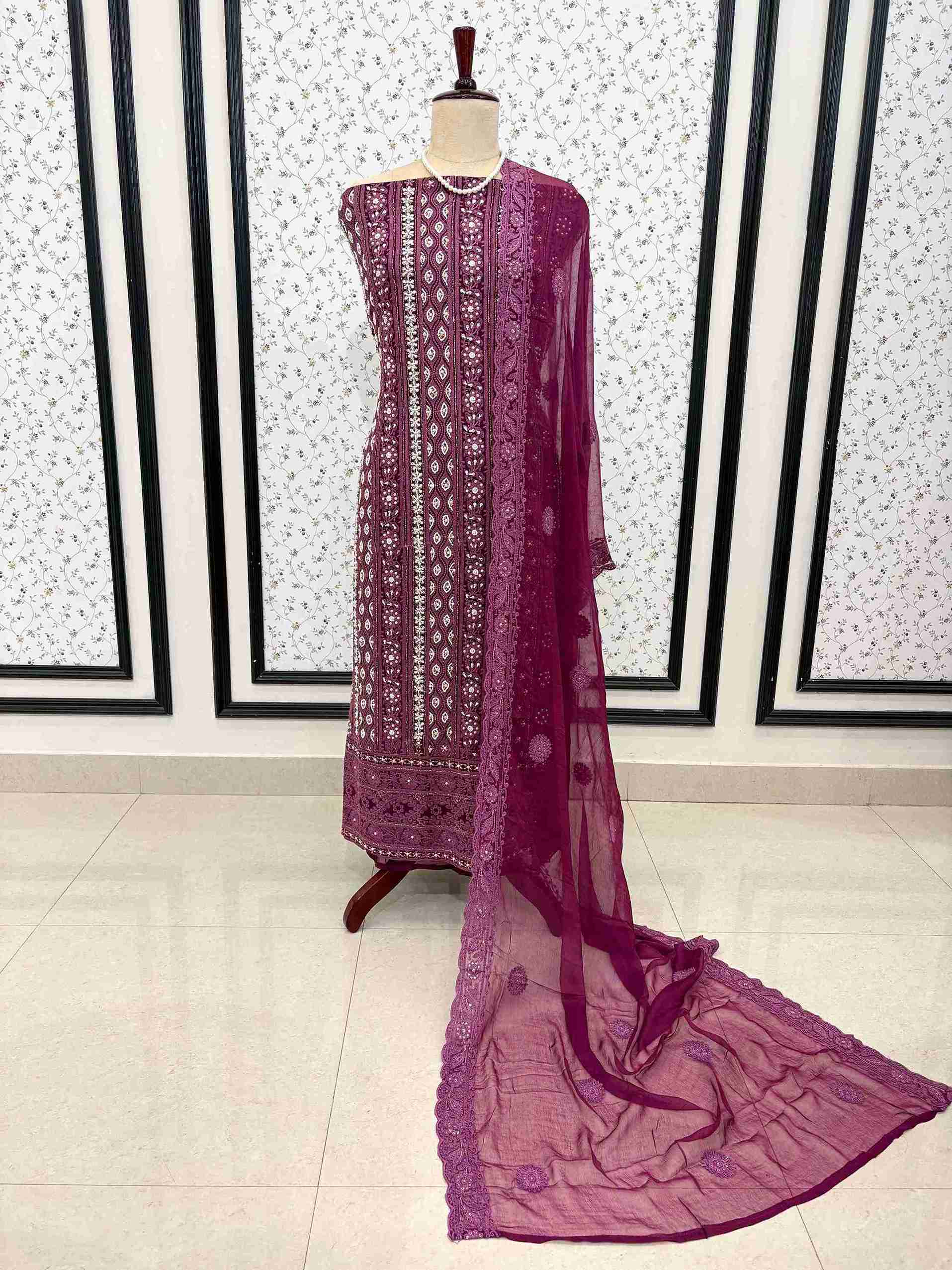 Detailed view of chikankari border work on wine purple suit fabric