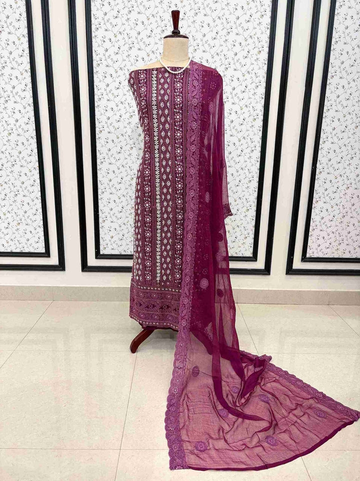 Detailed view of chikankari border work on wine purple suit fabric