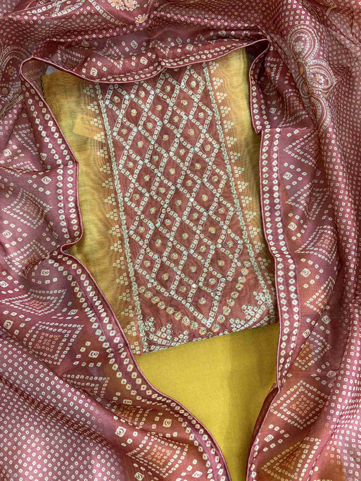 Close-up of all-over bandhni print with zari thread work detailing on yellow chanderi silk shirt