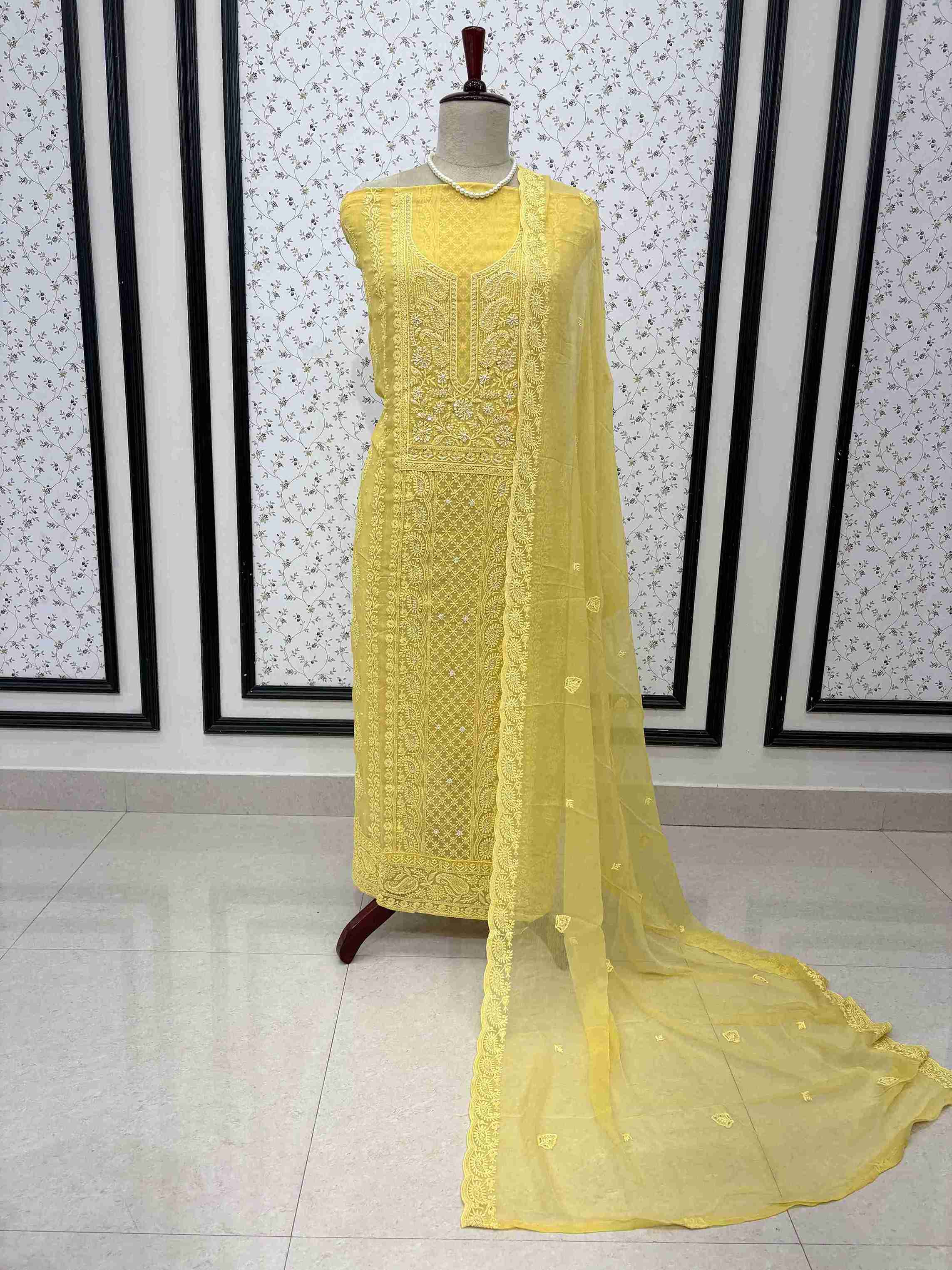 Scattered chikankari floral motifs across the surface of yellow chiffon dupatta