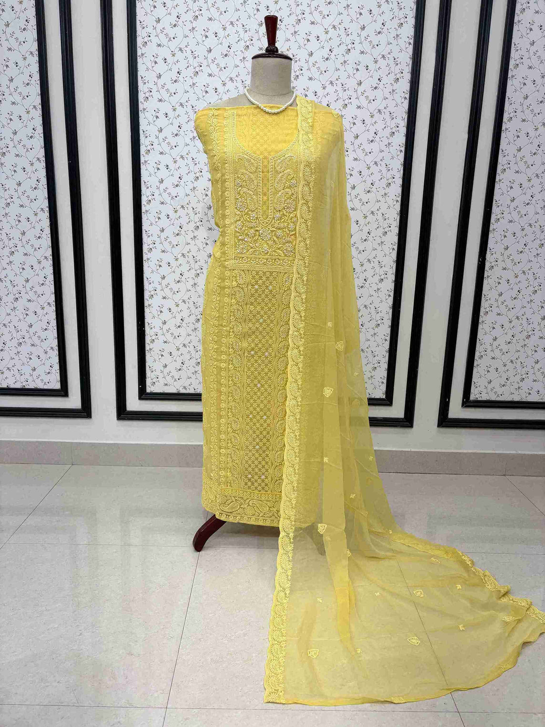 Scattered chikankari floral motifs across the surface of yellow chiffon dupatta