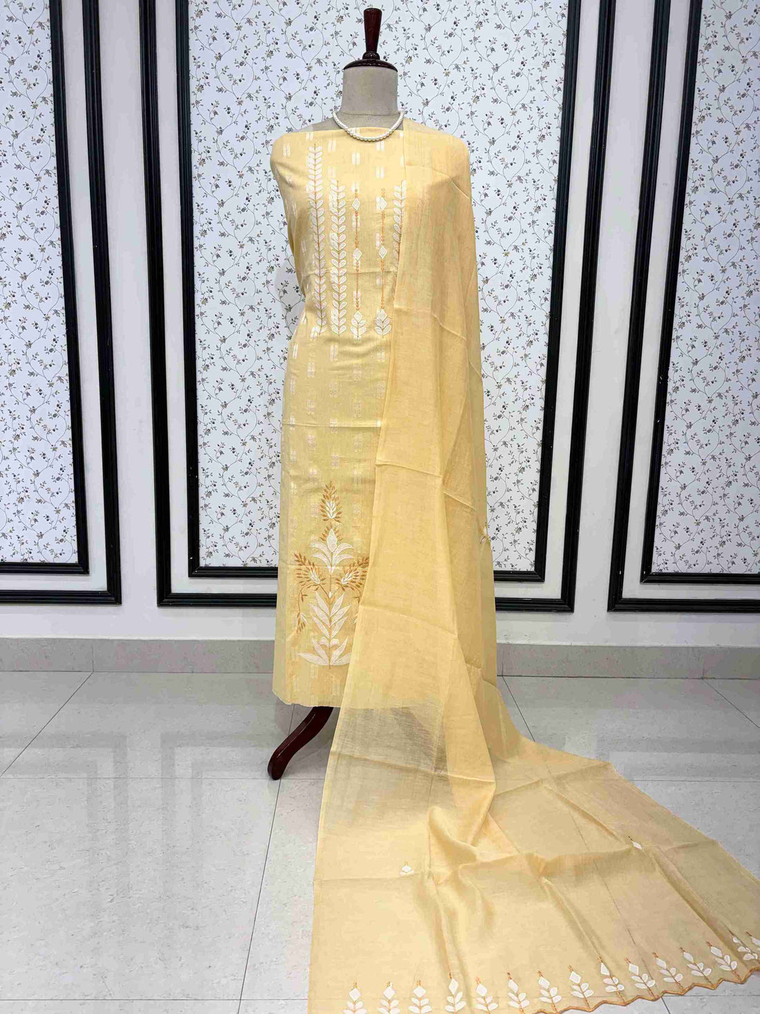 1. yellow cotton unstitched suit full front view with mul cotton cutwork dupatta draped on mannequin