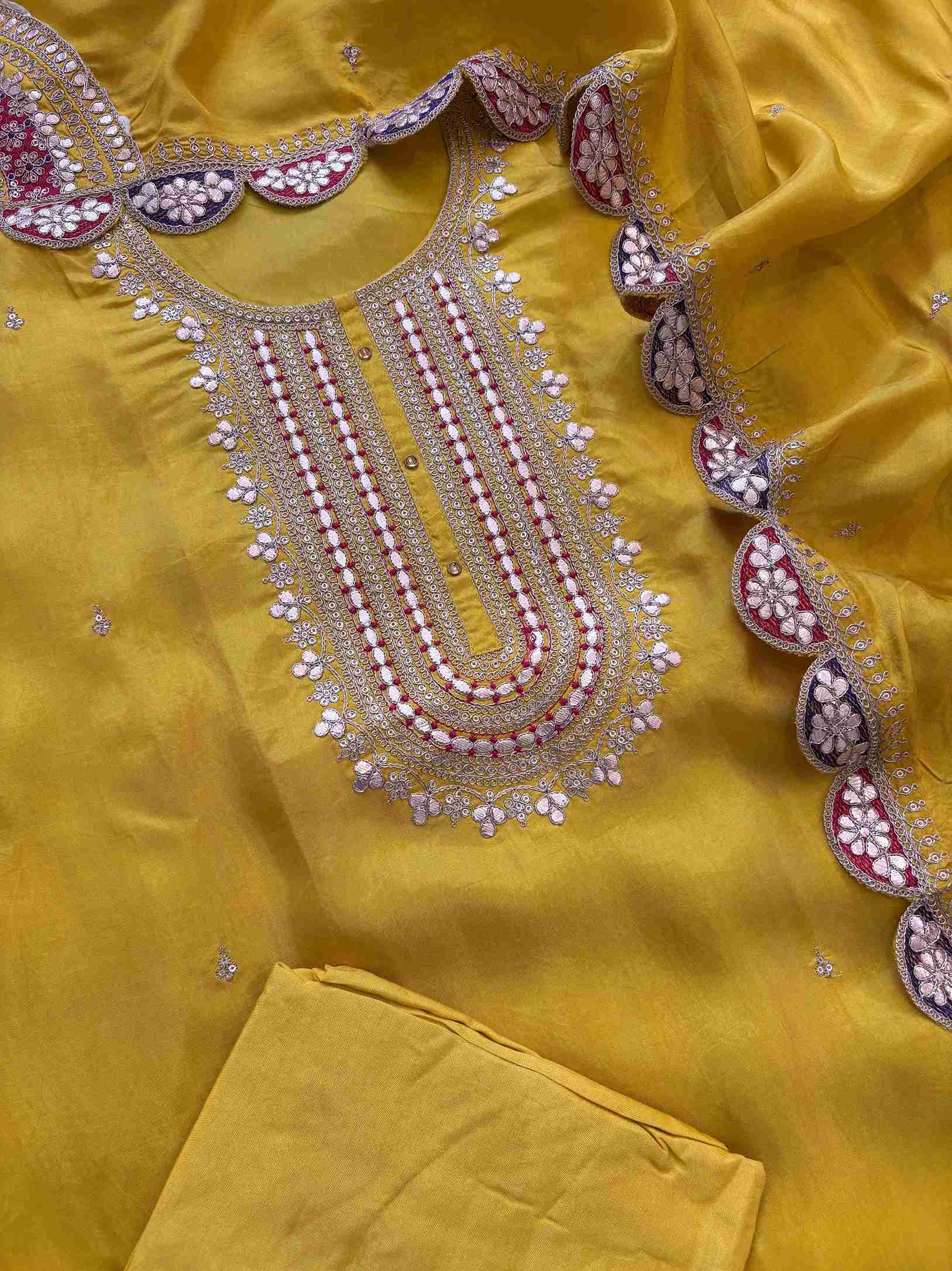 Complete yellow embroidered unstitched suit set with kurta, dupatta, and bottom