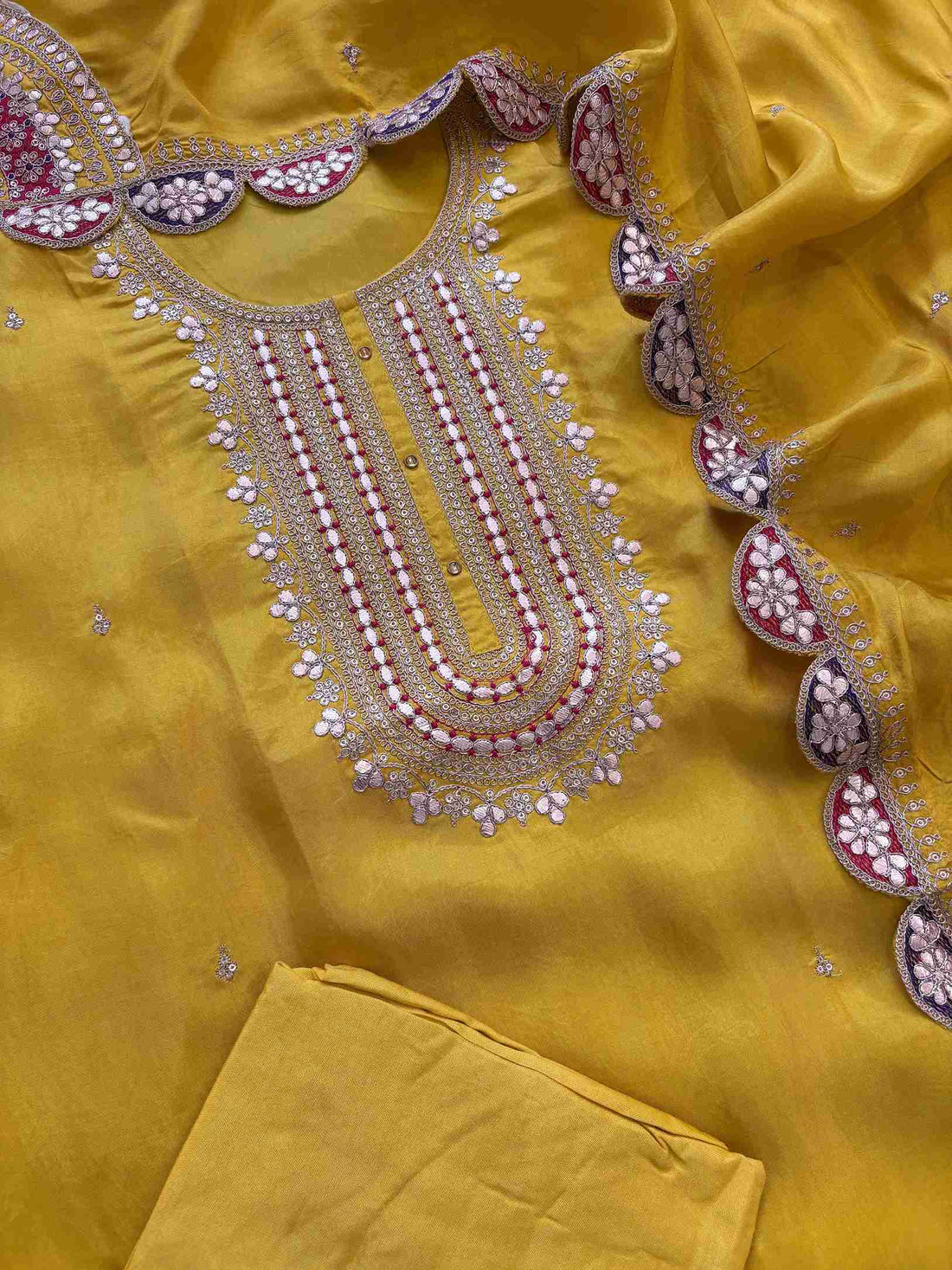 Complete yellow embroidered unstitched suit set with kurta, dupatta, and bottom