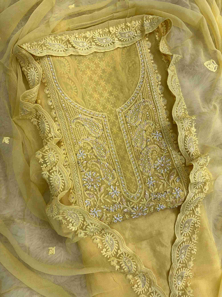 Close-up of chikankari neckline panel with moti, bead, and sequin embellishment on yellow georgette shirt