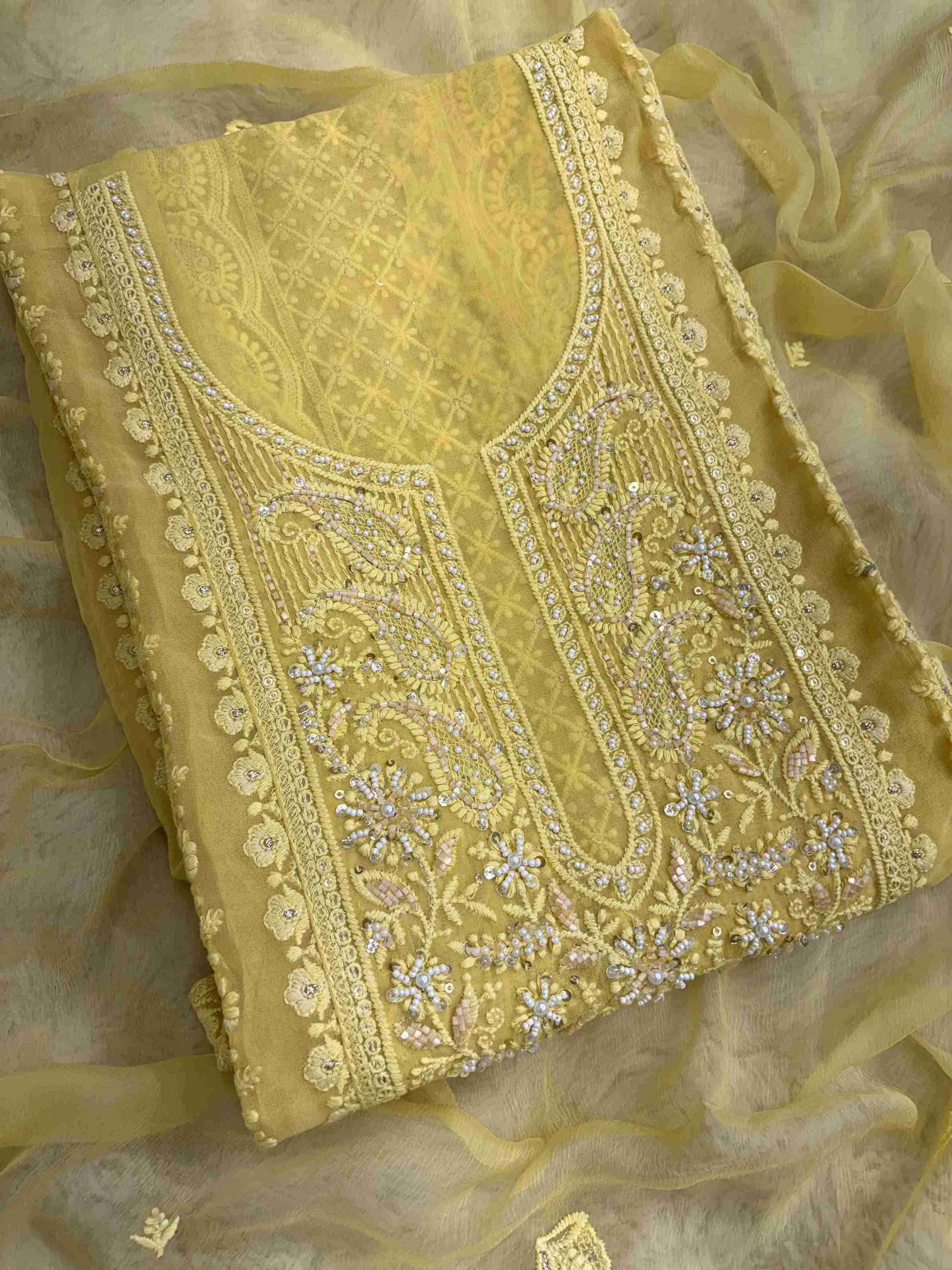 Geometric chikankari panel with paisley and floral motifs on yellow georgette shirt front