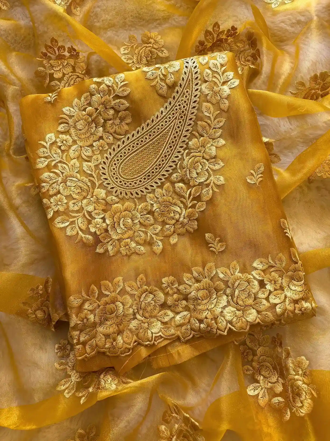Close-up of tone-on-tone floral thread embroidery on glass tissue fabric