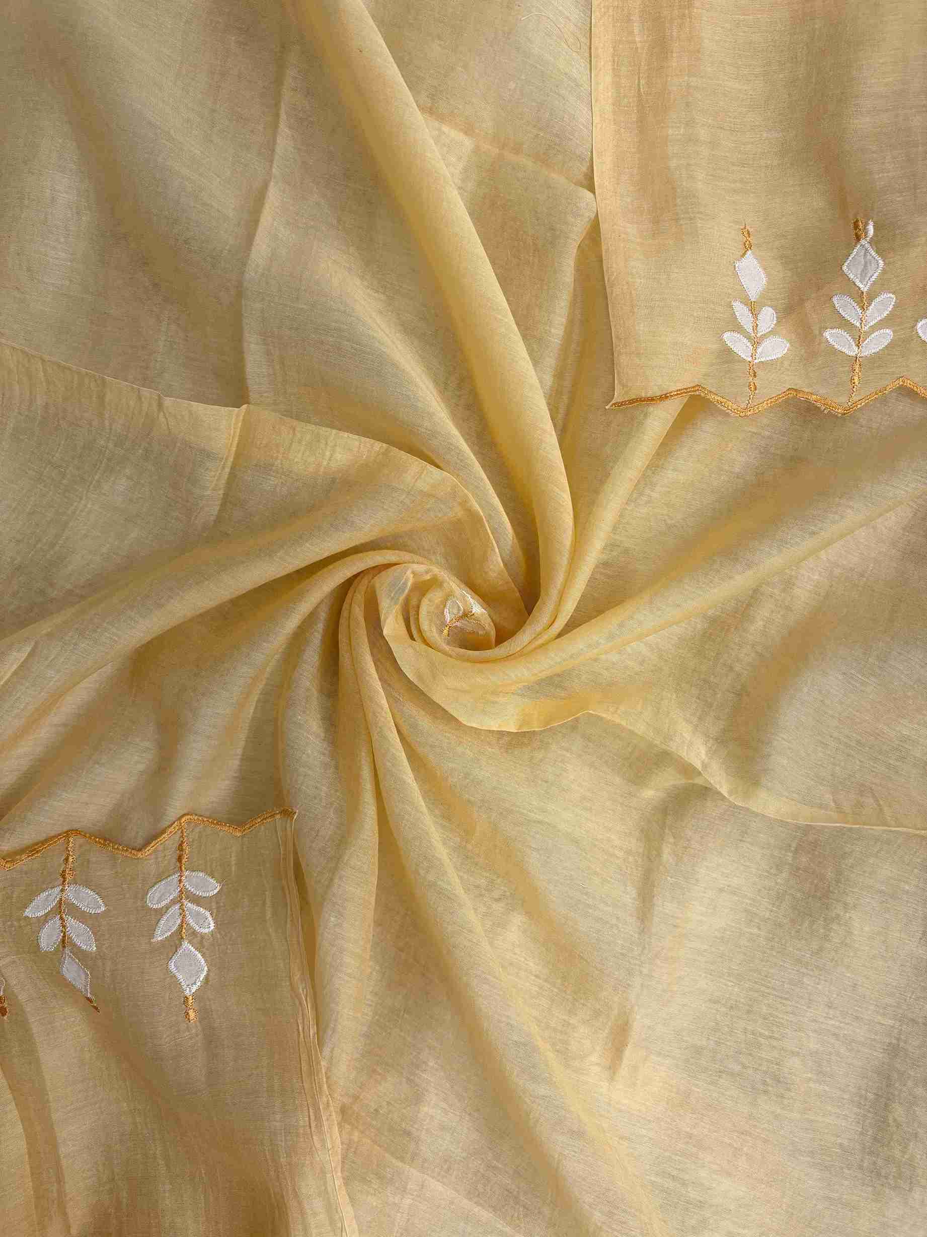 Applique patched cutwork border detail along yellow mul cotton dupatta hem