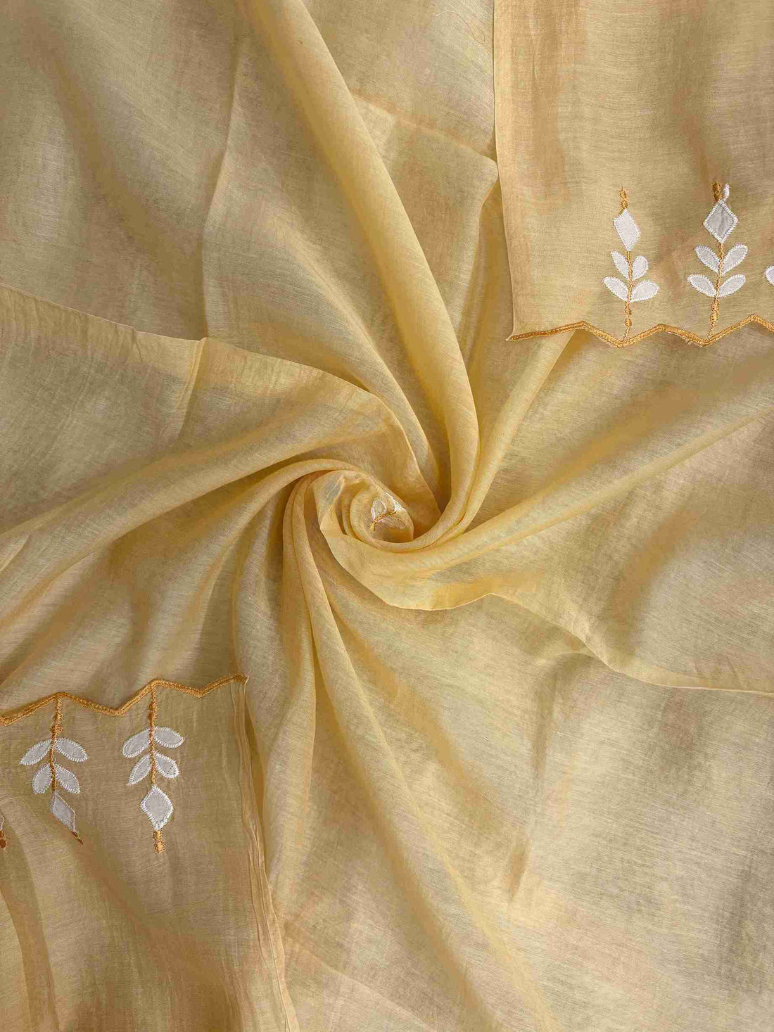 Applique patched cutwork border detail along yellow mul cotton dupatta hem