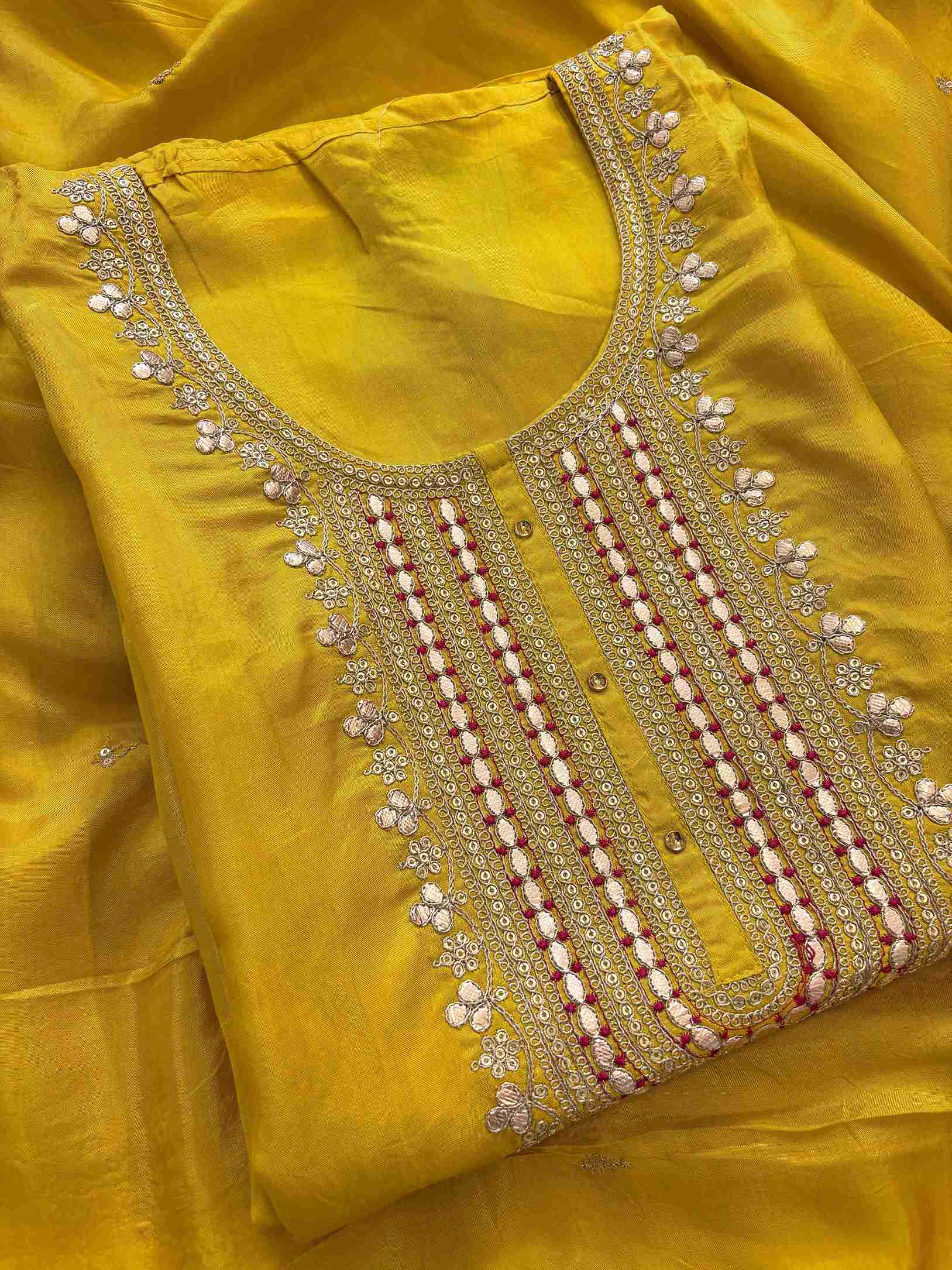 Close-up of embroidered neckline on yellow Russian silk kurta fabric